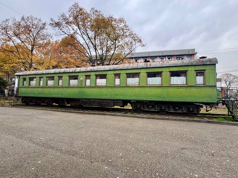 Old train carriage in an outdoor setting.