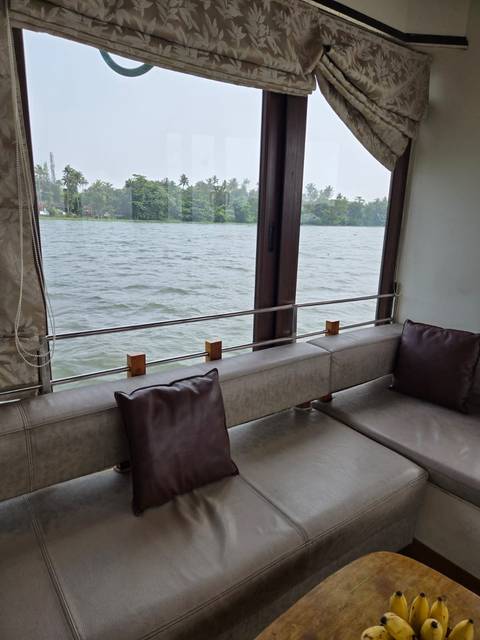 Interior of a boat with a view of the water through windows.