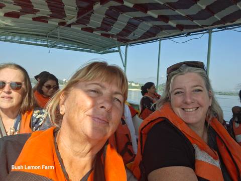 Group of people wearing life jackets on a boat ride.