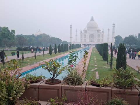 View of the Taj Mahal with gardens and reflection pool.