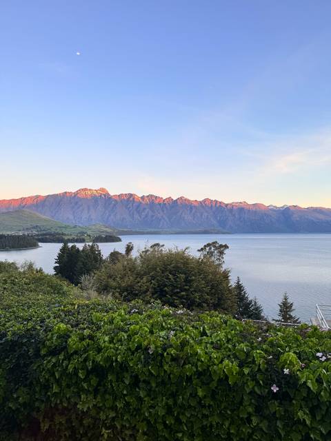 Mountain landscape with a lake under a clear sky.