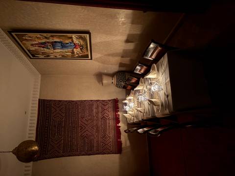       Dining table with candles set up in a decorated room.
  