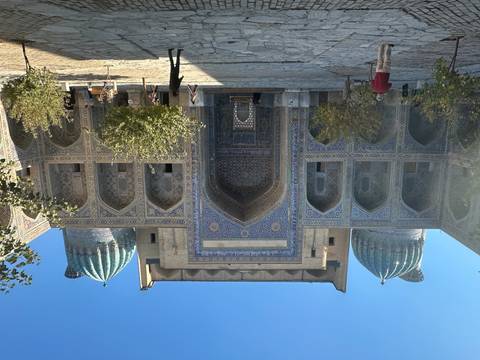       An ornate building with blue domes and intricate tile work.
  