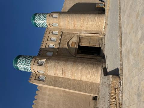       Traditional architecture with tiled towers and wooden door.
  