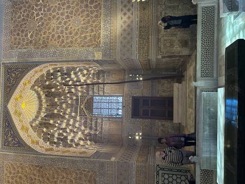       Interior of a mosque with intricate geometric patterns.
  