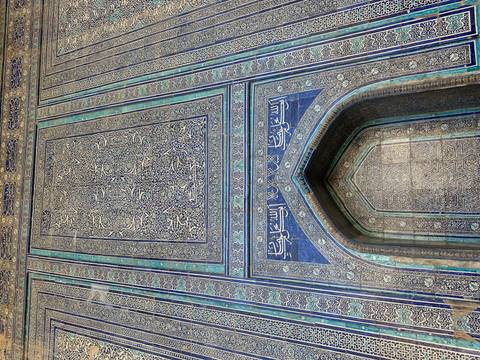       Detailed facade with blue tile work and inscriptions.
  