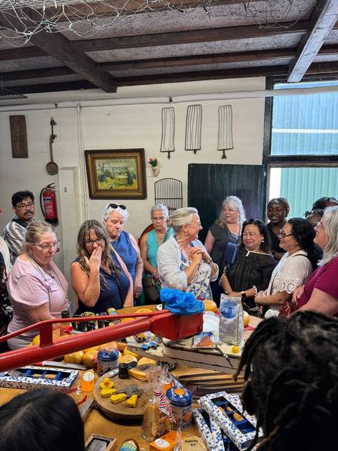 Group of people indoors smiling and talking.