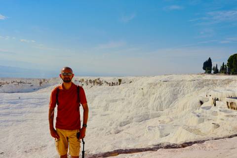 A person standing in front of Pamukkale's landscape.