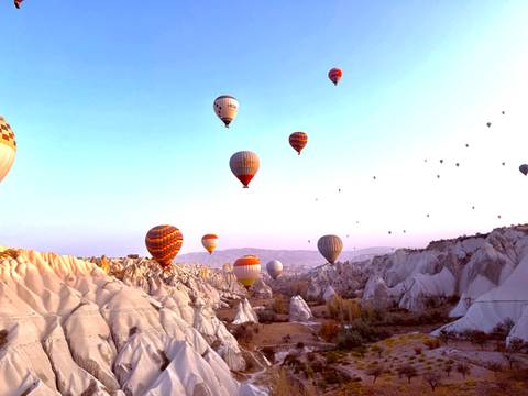       Hot air balloons over Cappadocia's landscape.
  