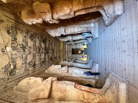       Interior view of an ancient temple hall with statues.
  
