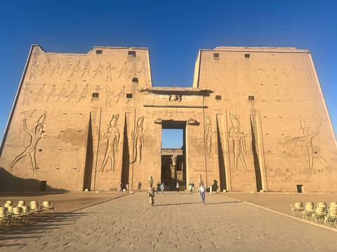      Facade of an ancient Egyptian temple with carvings.
  