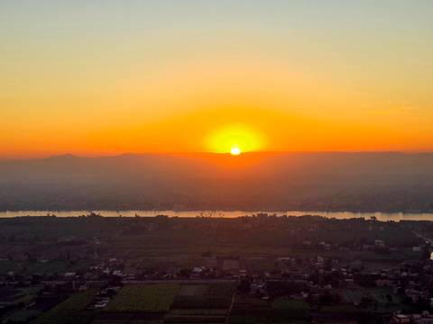       Sunset view over a river and landscape.
  