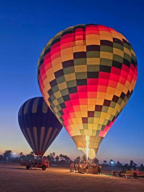       Close-up of colorful hot air balloons ascending.
  