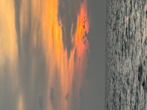 Sea with a colorful sunset in the background.