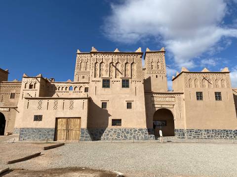 High walls of a traditional adobe fortress under a clear sky.
