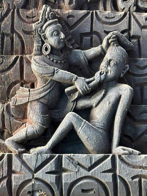       Intricate wooden carving depicting a historical scene.
  