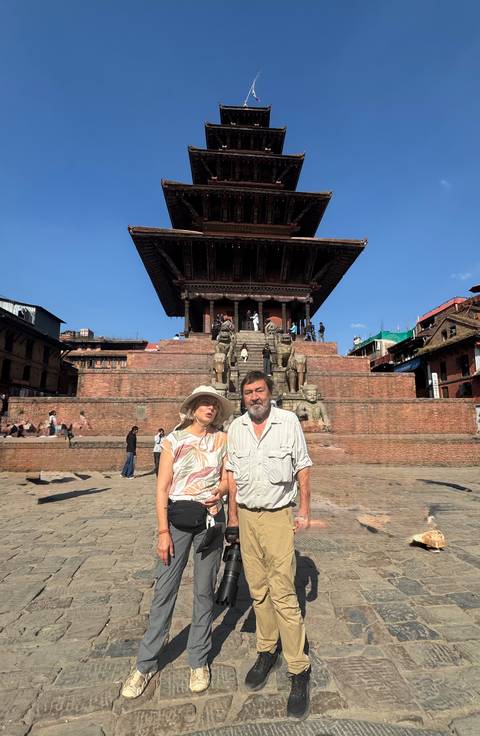       Couple posing in front of an ancient temple structure.
  