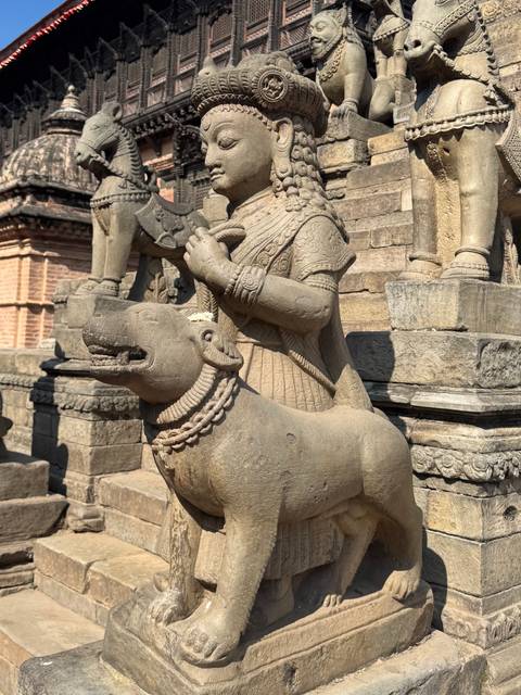       Statue of a historical figure with a domesticated animal.
  