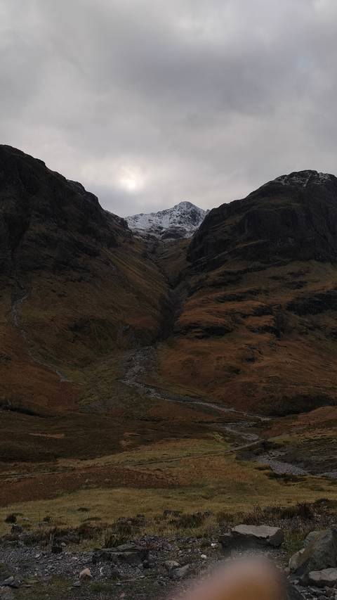 Remote mountain landscape with sparse vegetation.