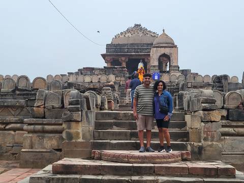 Tourists standing on ancient temple steps.