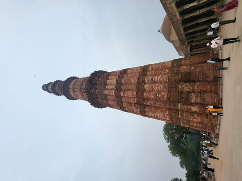 Historic tower with people at the base.