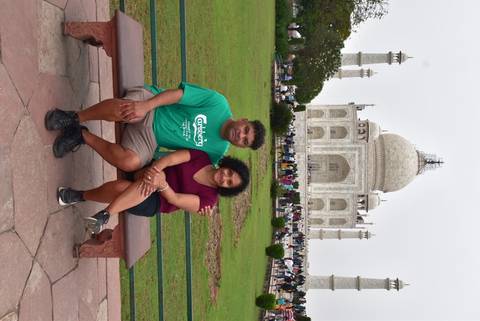 Couple sitting in front of the Taj Mahal in Agra, India.
