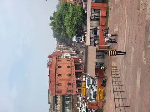 Busy street view in an Indian city with people and vehicles.