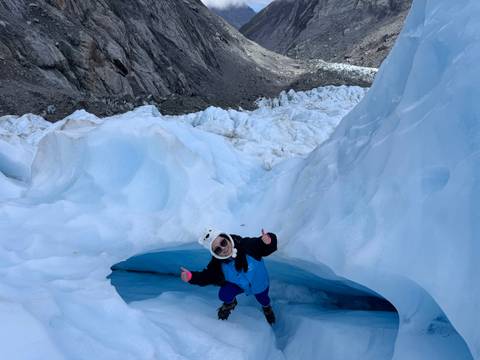 Person standing on snow in a glacier landscape