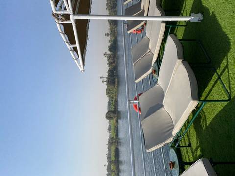       Sun loungers on a deck with river view.
  