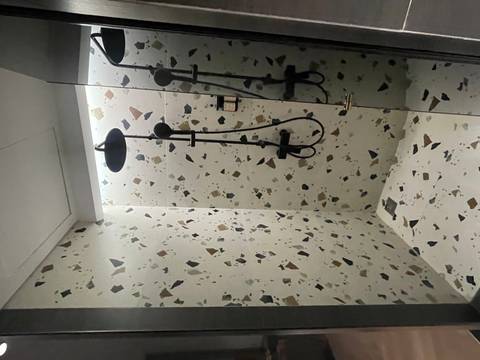       Modern shower cubicle with terrazzo walls.
  