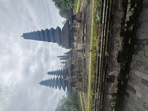 Multiple temple structures with pagoda-style roofs in cloudy weather.