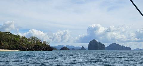 Ocean view with distant islands and a partly cloudy sky.