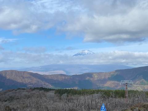 View of Mount Fuji with clouds partially covering it.