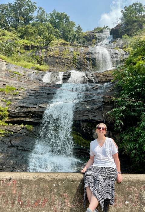       Person in front of a waterfall.
  