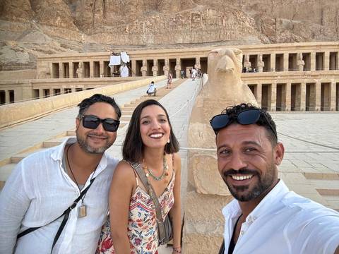 Group of people posing in front of an ancient Egyptian temple.