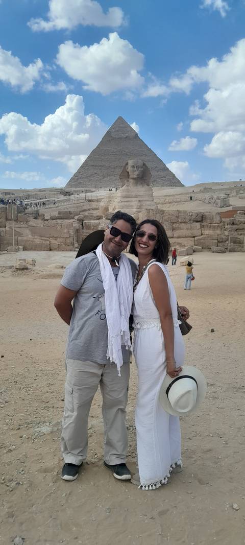       Couple posing with ancient stone structures in the background.
  