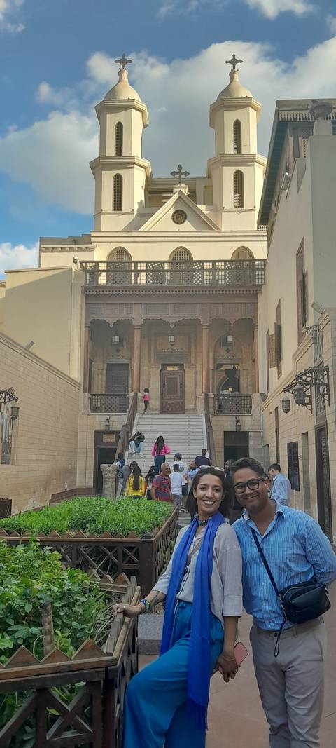 Tourists walking up steps to a historical building.