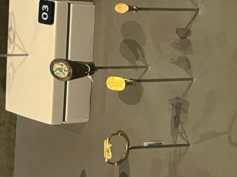       Close-up of ancient artifacts on display cases.
  