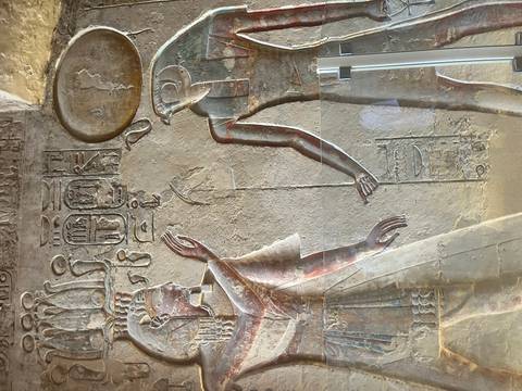 Carved wall art depicting ancient Egyptian royalty.