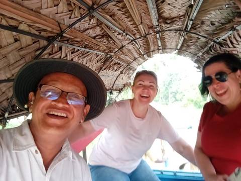 Group selfie in a rustic boat structure.