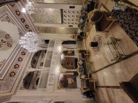       Luxuriously decorated interior with ornate furniture and chandeliers.
  