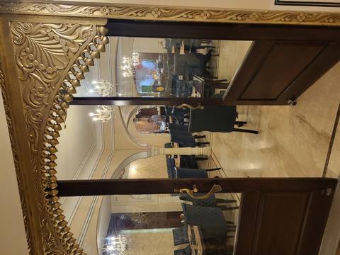       Restaurant interior with elegant chandeliers and dining tables.
  