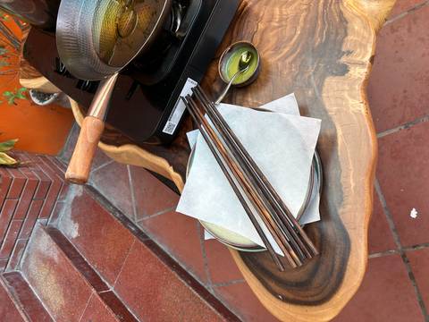 Cooking setup with utensils and ingredients on a unique table.