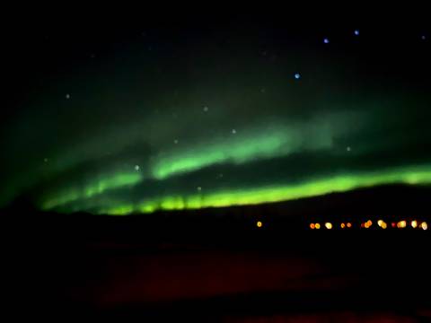 Blurry image of Northern Lights with bright spots.