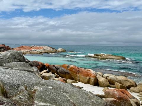       Rocky coastal area with patches of turquoise water.
  