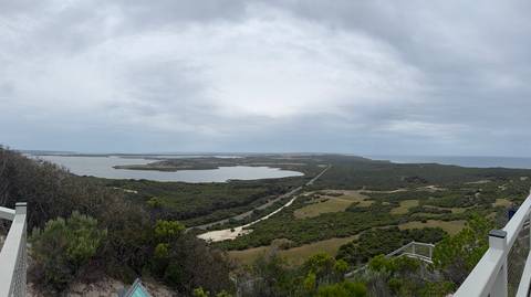       A wide view of coastal landscape with sandy inlets.
  