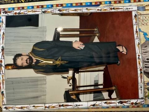       Person indoors wearing traditional attire.
  