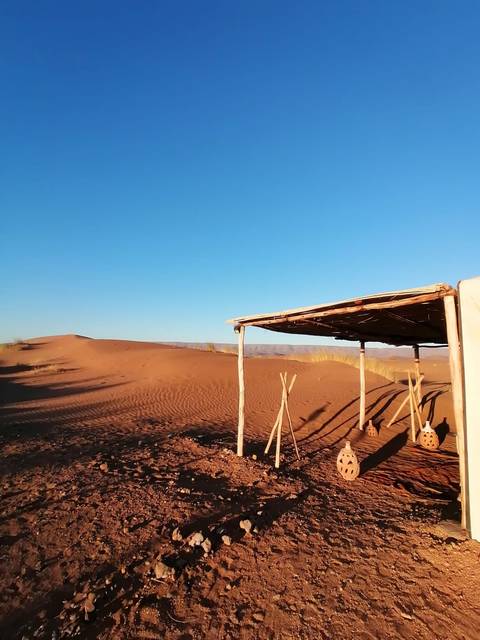 Simple structure casting shadows in the desert.