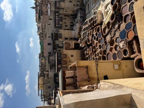       Traditional tanneries with rows of dyeing vats in a Moroccan city.
  