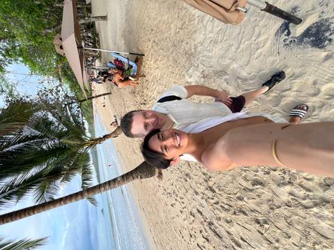 Two people taking a selfie on the beach.
